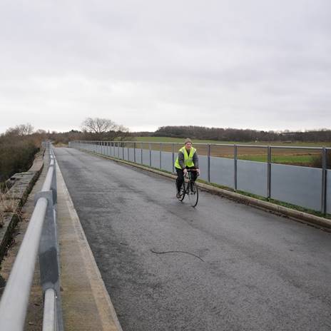 Man cycles across cycle route bridge