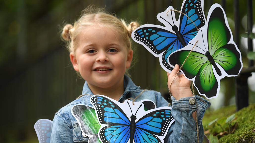 Young girl smiling with butterflies 